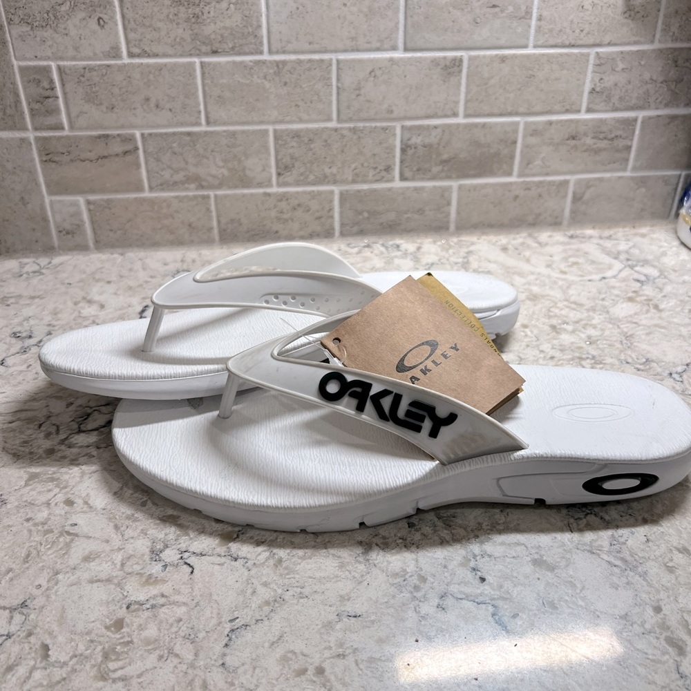 Oakley sandals/flip flops. All white. Mens size 11. Brand new with tags.